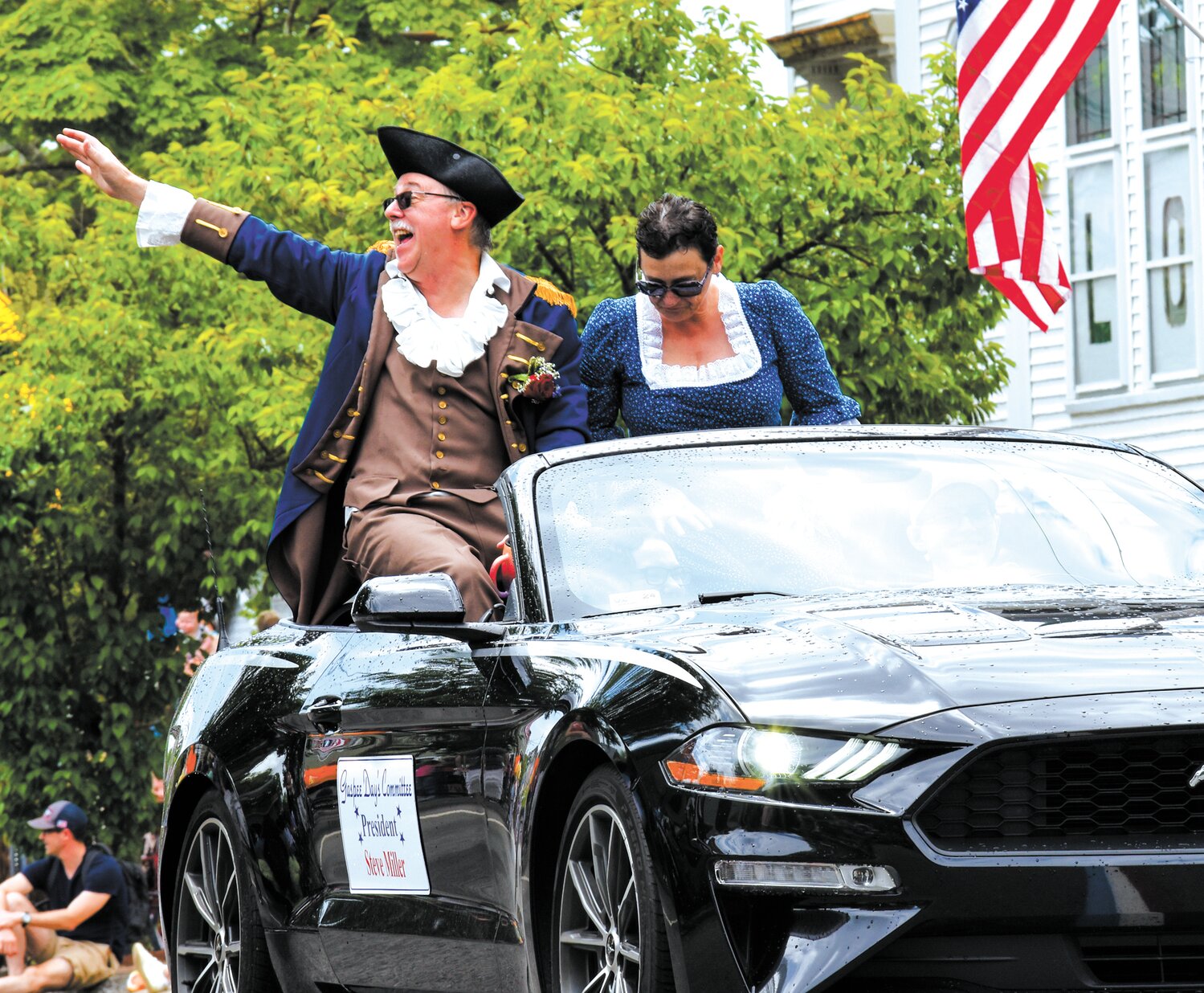 WHAT HE LOVES: Gaspee Days president Steve Miller accompanied by his wife, Tracey, waves to parade spectators Saturday. (Cranston Herald photo)